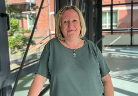 Junge Frau mit braunen Haaren und Brille